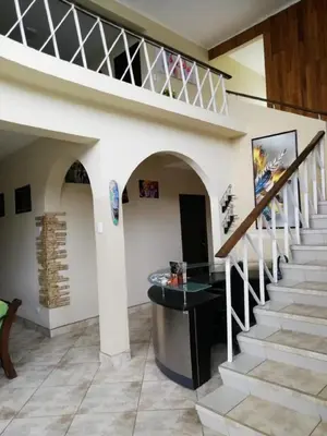 a staircase in a house with a stair case at HOTEL TERRAZAS BOUTIQUE in Los Yoses