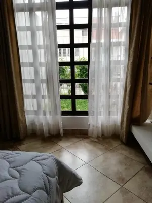 a bedroom with a bed and a large window at HOTEL TERRAZAS BOUTIQUE in Los Yoses