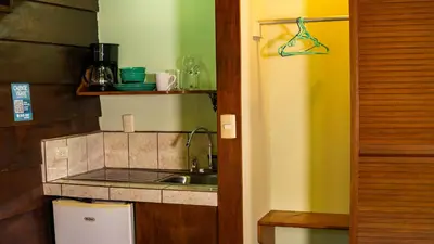 a kitchen with a sink and a counter top at La Fortuna Waterfall Bungalows in Fortuna