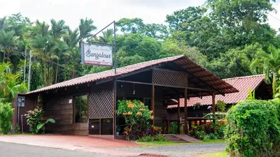 a small building with a sign in front of it at La Fortuna Waterfall Bungalows in Fortuna