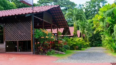 a building with a bunch of flowers in it at La Fortuna Waterfall Bungalows in Fortuna