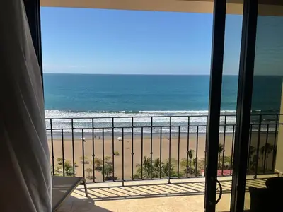 a view of the beach from a balcony at Jaco Oceanfront Condo #1119 in a Luxury Resort in Jacó