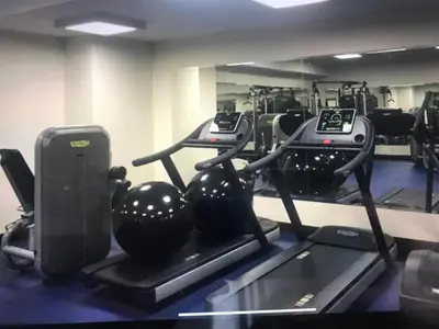 a gym with two treadmills and exercise bikes at Jaco Oceanfront Condo #1119 in a Luxury Resort in Jacó