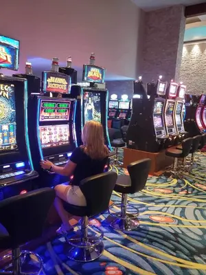 a woman sitting in front of slot machines in a casino at Jaco Oceanfront Condo #1119 in a Luxury Resort in Jacó