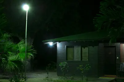 a house with a street light next to it at night at Cañon de la Vieja Lodge in Liberia