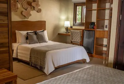 a bedroom with a bed and a television at Buena Vista del Rincón Eco Adventure Park Hotel & Spa in Liberia