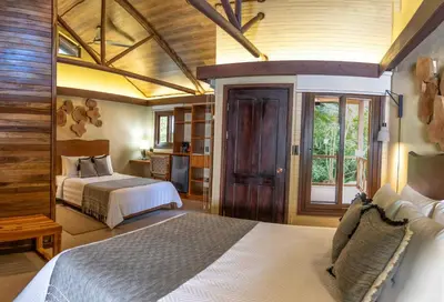 a large bedroom with two beds and a window at Buena Vista del Rincón Eco Adventure Park Hotel & Spa in Liberia