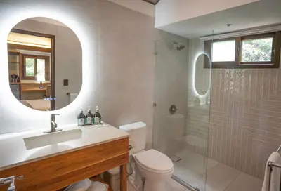 a bathroom with a toilet and a sink and a shower at Buena Vista del Rincón Eco Adventure Park Hotel & Spa in Liberia