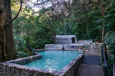 a pool of water with a playground in a garden at Buena Vista del Rincón Eco Adventure Park Hotel & Spa in Liberia