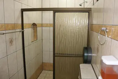 a shower with a glass door in a bathroom at Cabinas Sueño Real in San Rafael