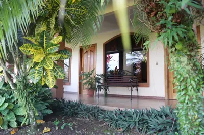 a building with a porch with a bench in it at Cabinas Sueño Real in San Rafael