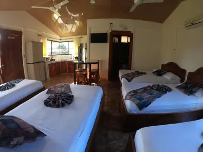 a living room with two beds and a kitchen at Cabinas Sueño Real in San Rafael
