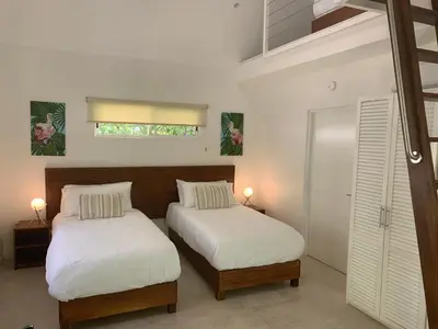 a bedroom with two beds and a window at Aves Resort Montezuma in Montezuma