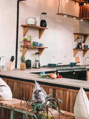 a kitchen with a counter and a counter top at El Gato Rojas Surf Hostel in Santa Teresa Beach