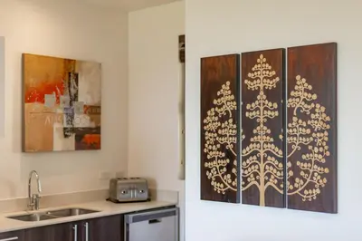 a kitchen with a wall with a christmas tree stencil at Adults Only 1BR Condo - Roble Sabana - Reserva Conchal Golf Resort in Playa Conchal
