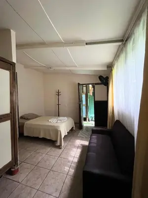 a bedroom with a bed and a couch in a room at Chilamate Rainforest Eco Retreat in Puerto Viejo