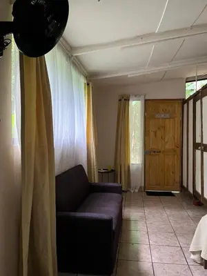 a living room with a couch and a window at Chilamate Rainforest Eco Retreat in Puerto Viejo
