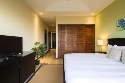 a bedroom with a large bed and a flat screen tv at Incredible Ocean-View Penthouse - Jobo - Reserva Conchal Golf Resort in Playa Conchal