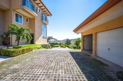 a driveway in front of a house with a garage at Corona del Mar #6 in Ocotal