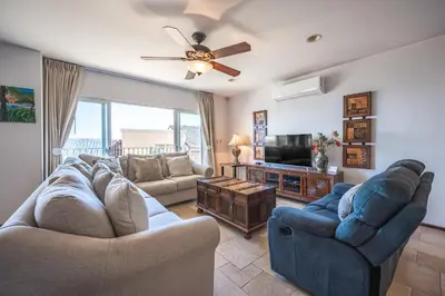a living room with two couches and a tv at Corona del Mar #6 in Ocotal