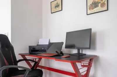 a desk with a computer and a monitor and a laptop at Lujoso condominio con lavadora y secadora, S. José in San José