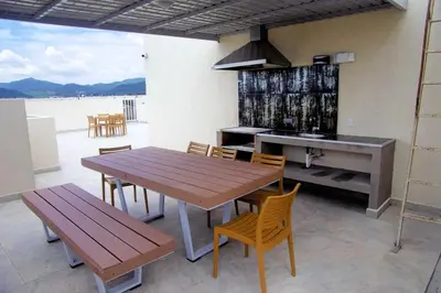 a kitchen with a wooden table and chairs and a sink at Lujoso condominio con lavadora y secadora, S. José in San José