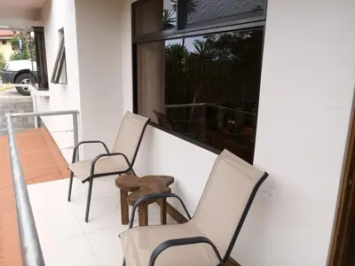 a group of chairs sitting on a porch at CASA GERANIOS # 2 in Monteverde Costa Rica