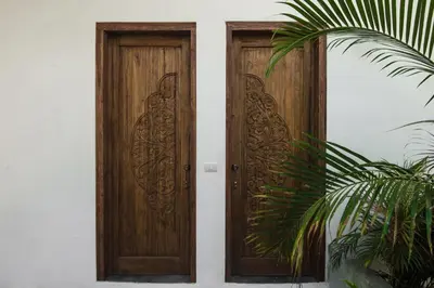 a wooden door on a house with a plant at Lucero in Santa Teresa Beach