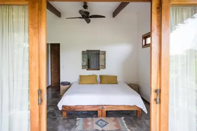 a bedroom with a bed and a ceiling fan at Lucero in Santa Teresa Beach