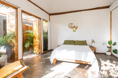 a bedroom with a bed and a large window at Lucero in Santa Teresa Beach