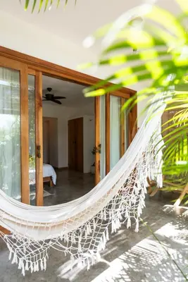 a hammock in the middle of a room at Lucero in Santa Teresa Beach