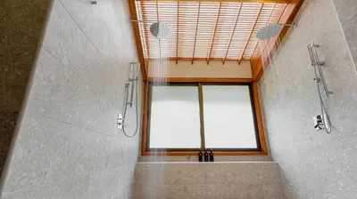 a bathroom with a shower and a large window at Tabacón Thermal Resort & Spa in Fortuna