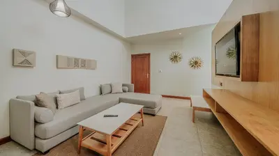 a living room with a couch and a tv at Tabacón Thermal Resort & Spa in Fortuna