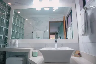 a white bathroom with a sink and a mirror at Bahia Pez Vela Resort in Ocotal