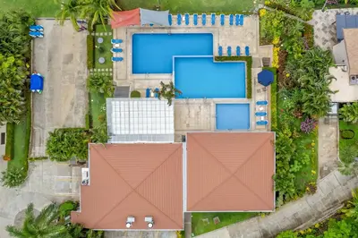 an overhead view of roofs with swimming pools at Bahia Pez Vela Resort in Ocotal