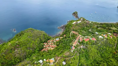 an aerial view of a resort on a hill next to the water at Bahia Pez Vela Resort in Ocotal