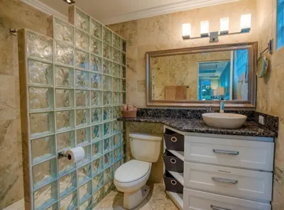 a bathroom with a toilet and a sink and a mirror at Bahia Pez Vela Resort in Ocotal