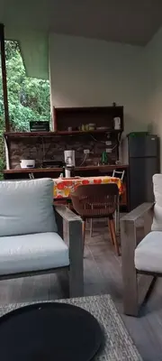 a living room with a couch and a piano at Selva Linda Lodge jungle wildlife vue and birdwatching in Quepos