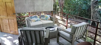 a patio with two chairs and a couch on a porch at Selva Linda Lodge jungle wildlife vue and birdwatching in Quepos