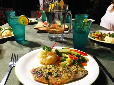 a plate of food on a table with vegetables and meat at Jungle Lodge at Wild Sun Rescue Center in Cabuya