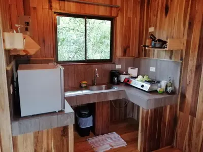 a small kitchen with a sink and a window at Jungle Living Tree Houses in Monteverde Costa Rica
