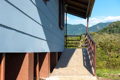 a staircase leading up to a building with mountains in the background at Calas Lodge in Bajos del Toro
