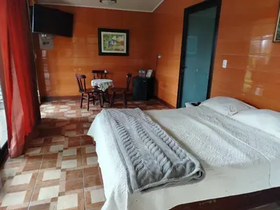 a bedroom with a bed and a table and chairs at Suite y Loft Casa Toría in San Isidro