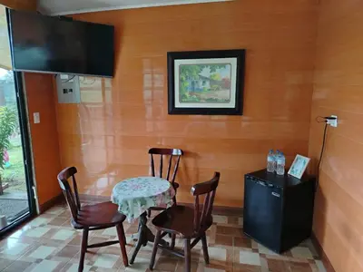 a dining room with a table and chairs and a flat screen tv at Suite y Loft Casa Toría in San Isidro