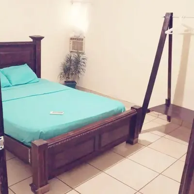 a bed with a wooden frame in a room at Apartamento 2 habitaciones - Morpho CR in Tejar