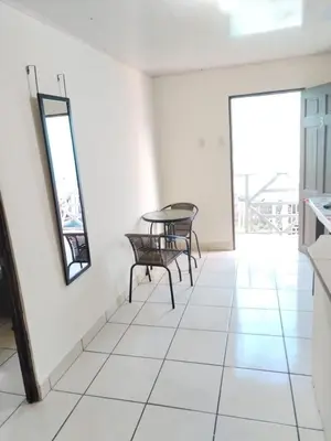 a room with a table and chairs and a window at Apartamento 2 habitaciones - Morpho CR in Tejar