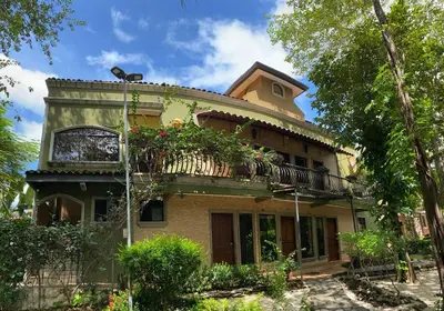 a house with a balcony on top of it at Casas del Toro Playa Flamingo in Playa Flamingo