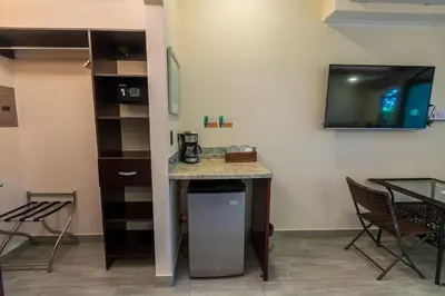 a room with a counter and a table and chairs at Casas del Toro Playa Flamingo in Playa Flamingo