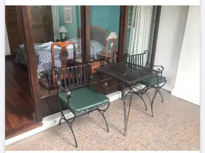 a room with a table and chairs and a bed at La Bergerac Boutique Hotel in San José