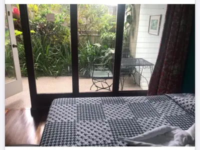 a bedroom with a bed and a view of a patio at La Bergerac Boutique Hotel in San José